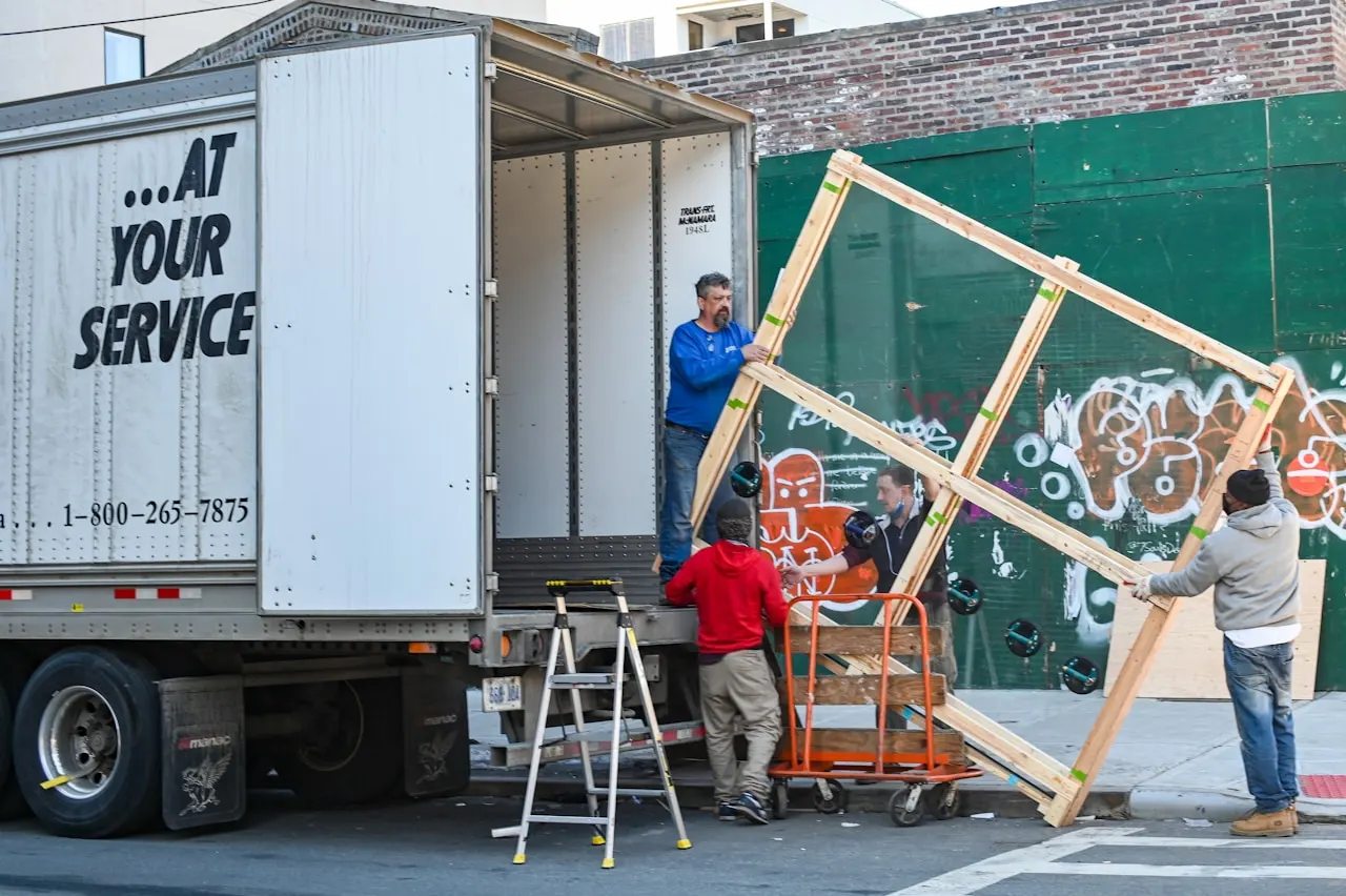 Junk removal crew loading furniture into a truck for junk removal near Newberry Florida