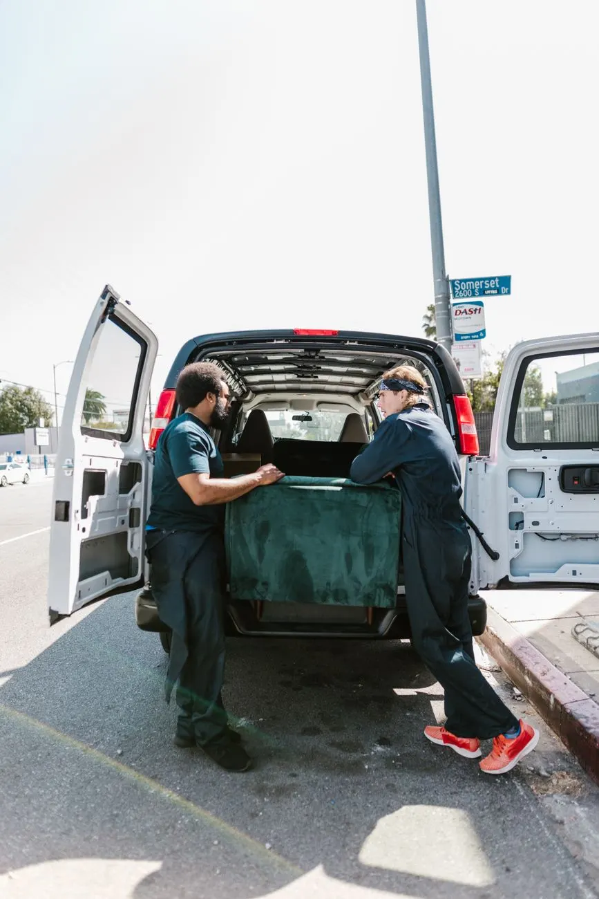 Junk removal crew loading a couch into a truck for junk removal in Gainesville, Fl