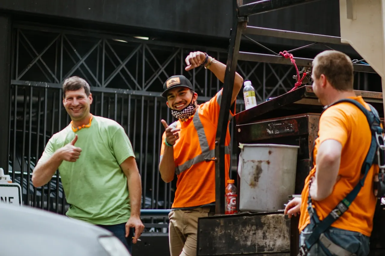Smiling junk removal crew with their loaded truck in Gainesville Florida